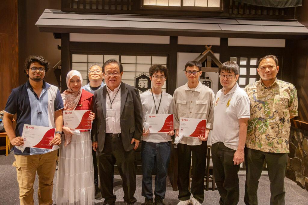 APIE Advanced Camp participants holding certificates at the closing ceremony